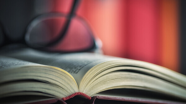 glasses laying on a book
